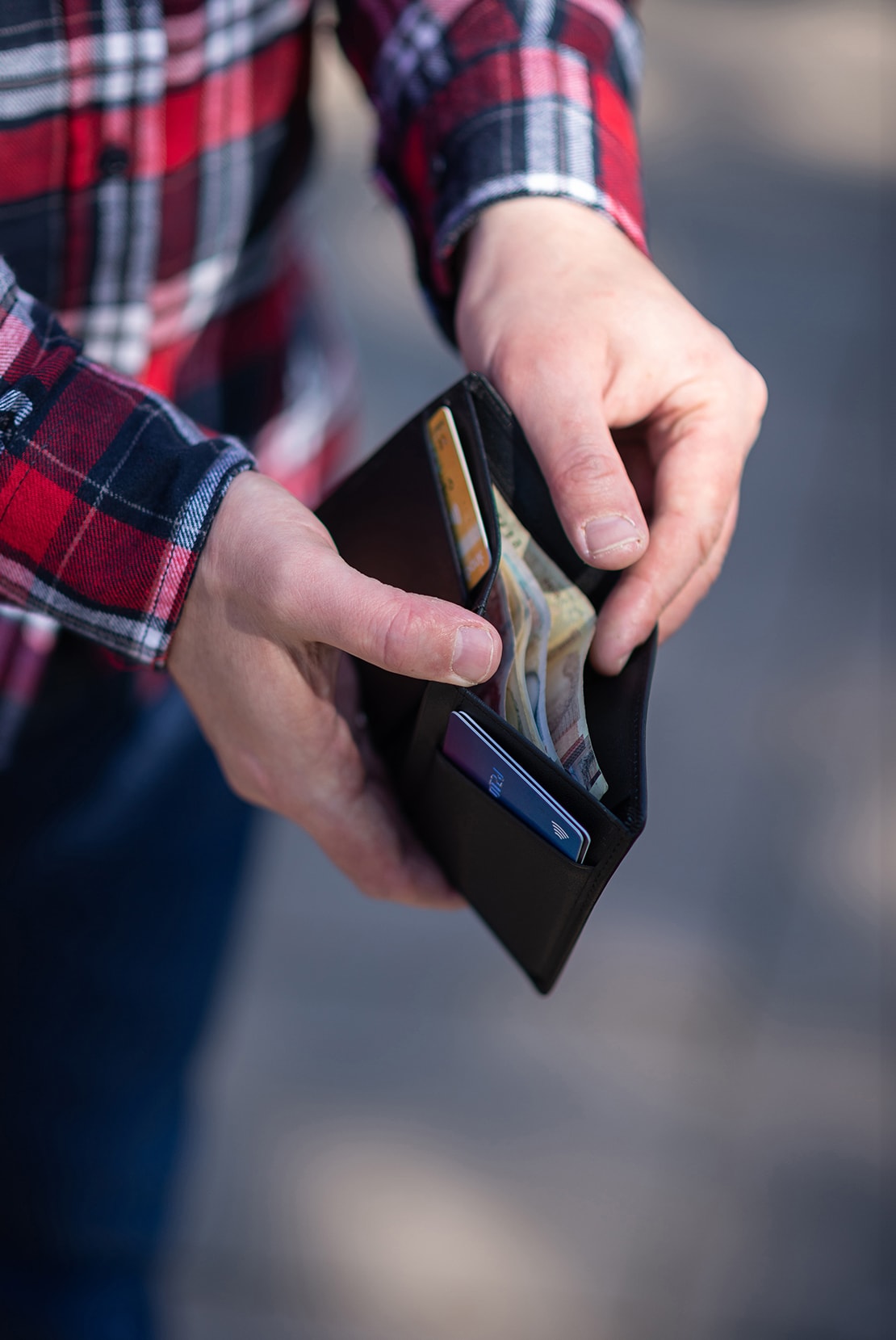 Person holding and opening wallet in hands